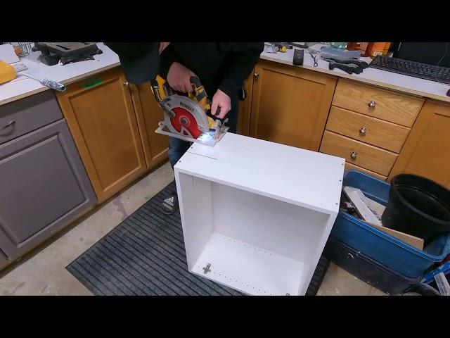 Cutting a cabinet with a circular saw to get around a pipe