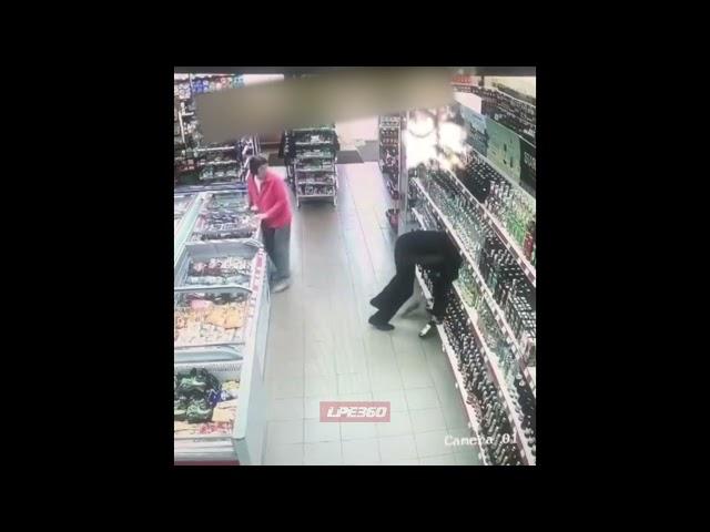 Drunk man falls in liquor shelf in store