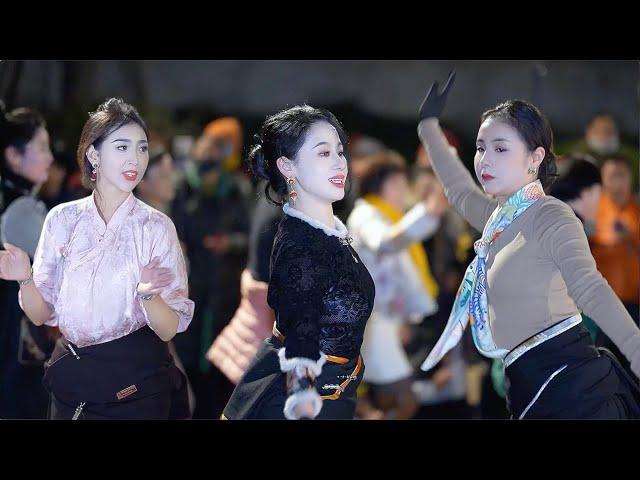 Beautiful Tibetan women gather together to dance cheerful Tibetan dances