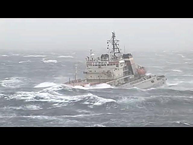 Rescue tug approach the aircraft carrier for towing