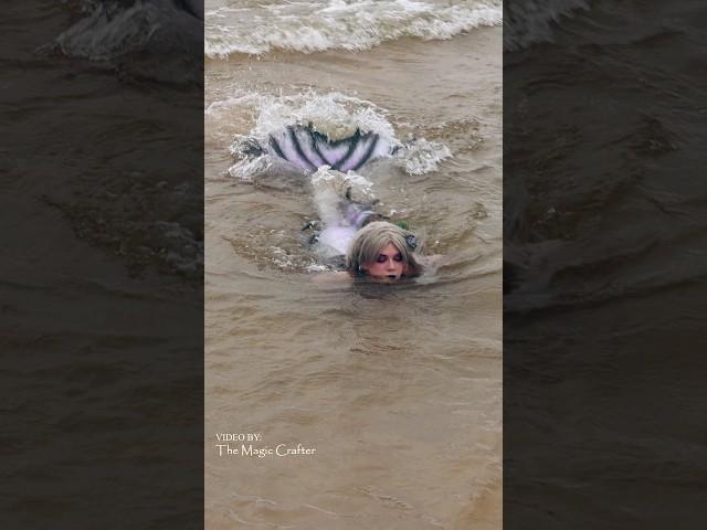 Mermaid gets forced out of the water by waves