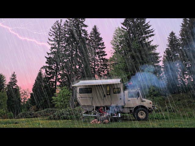 CAMPING WITH A UNIMOG CAMPER AT A RAINY SUNSET