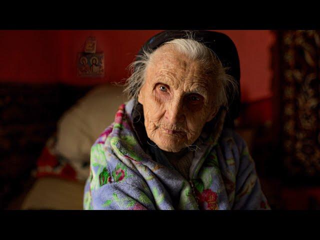 Severe old age of a 96 year old grandmother with her son in a high mountain village