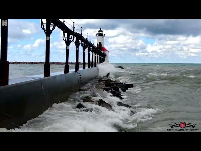 Waves Hitting Drone As They Wash Over Lighthouse & Pier 4K Drone Footage