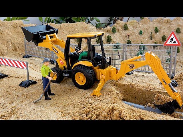 Retroescavadeira trabalhando brinquedos de veículos de construção