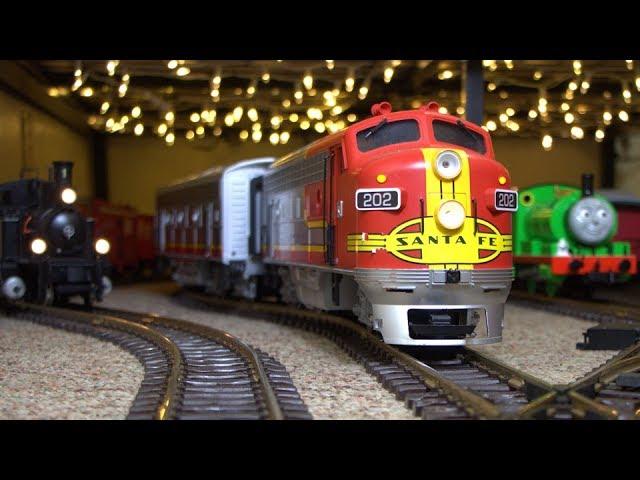 A Model Train Runs Between Two Houses