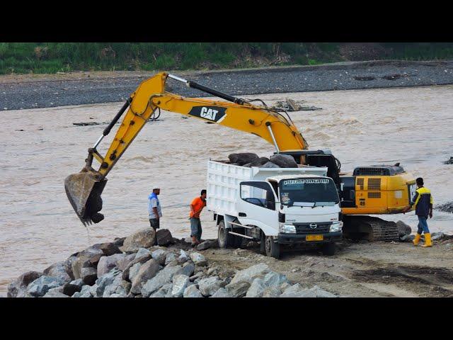 CAT 336 Excavator Dump Truck continuously Making Piles of Rocks