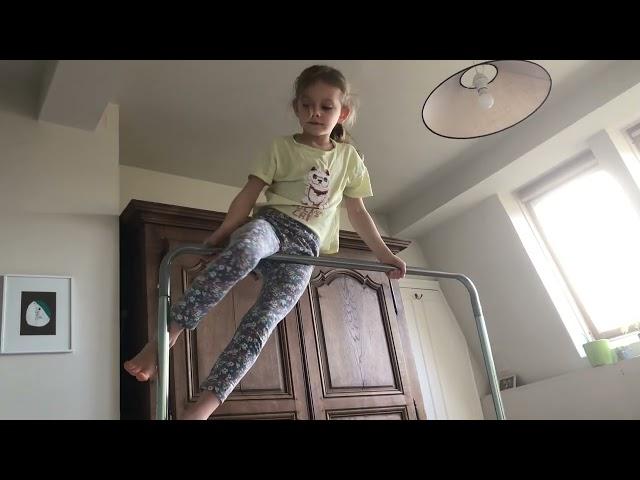 Gymnastics tricks on the bar for kids