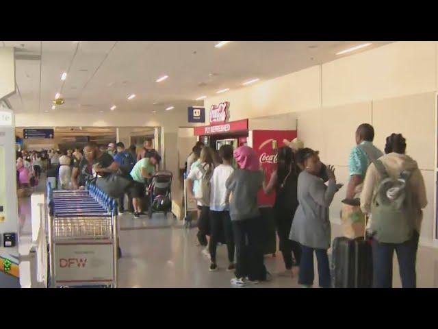 Travelers wait in long lines at Dallas Fort Worth International Airport after tech outage