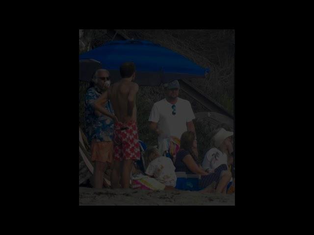 Leonardo DiCaprio relaxing with friends and father on the beach in Malibu.