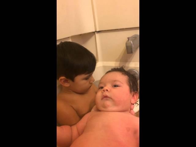 TODDLER GIVES BABY BROTHER A BATH !