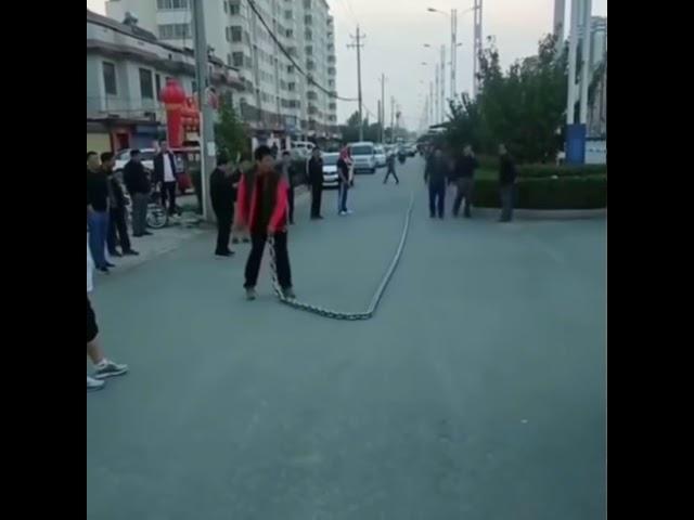 Guy whipping giant chain whip