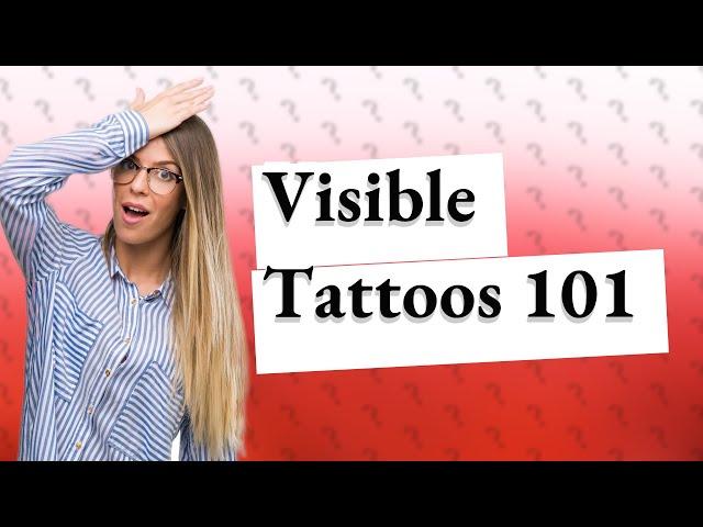 What is considered a visible tattoo?