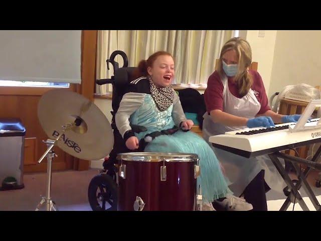 Freya enjoying music therapy with Ceridwen at Little Bridge House