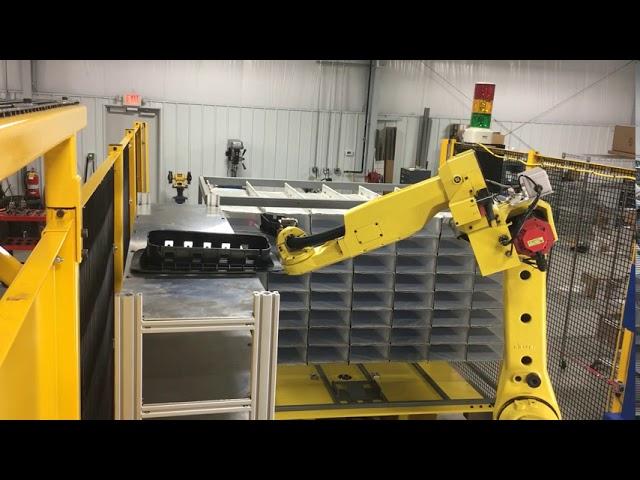 Automated Fanuc cell with 2D laser marking, short shot detection, and packing with laser assist.