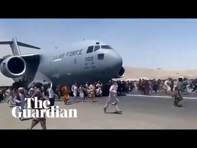 Afghans climb on to plane during takeoff in attempt to flee Taliban