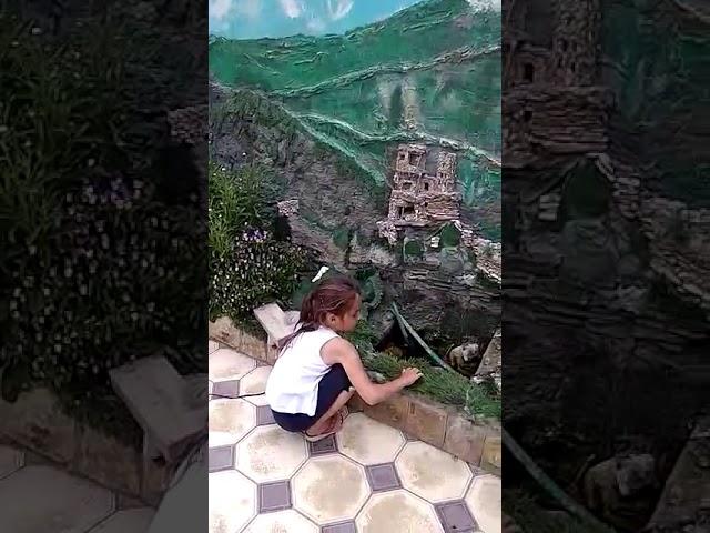 Miniature mountains and a brook in the courtyard of the house