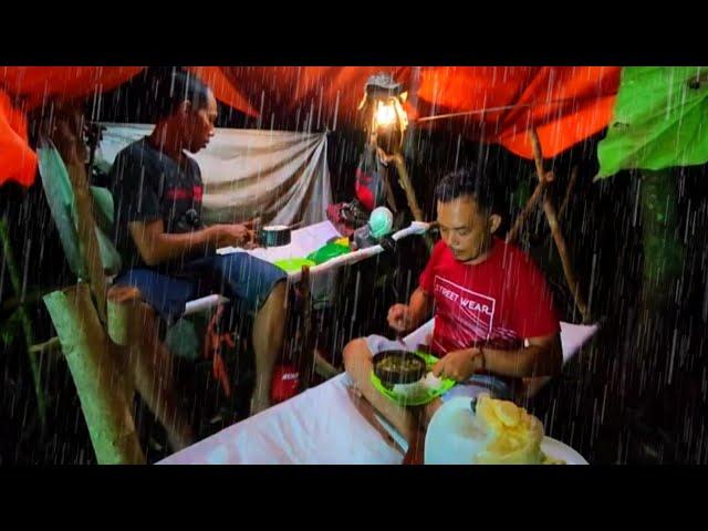 Camping in heavy rain, simple shelter on the river bank - looking for fish for dinner