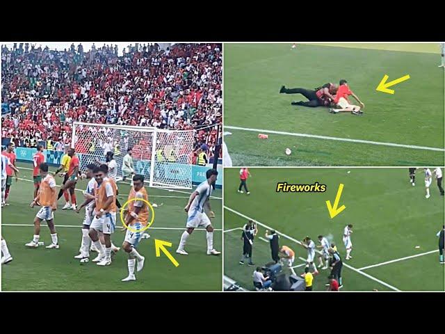 Angry Moroccan Fans stormed into the pitch and threw bottles & flares at Argentina Players