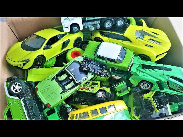 A box full of green car models