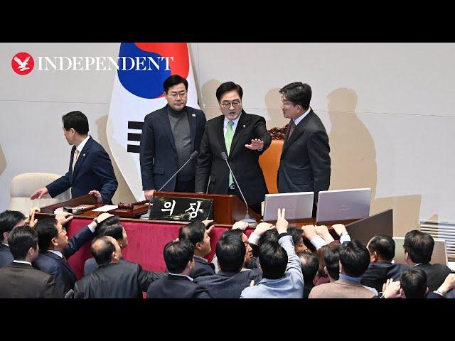 Chanting South Korean ruling party lawmakers swarm parliament in protest of impeachment vote