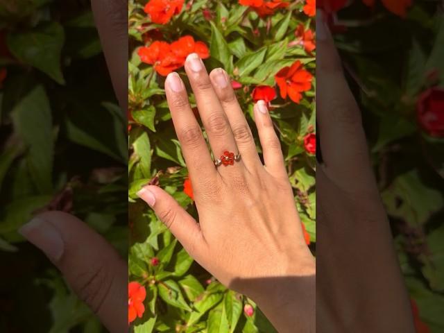 Just like magic 🪄 Thoughts on this new design? #orange #flowerring #goldring #crystalaccessories