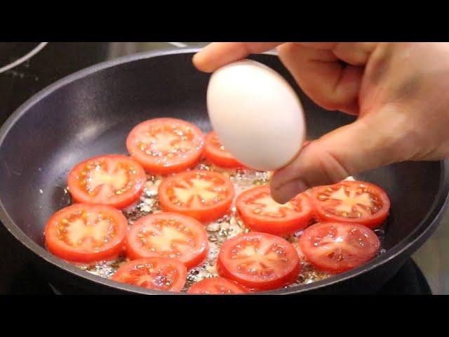 I have never eaten such delicious eggs. Fried eggs with tomatoes in a pan