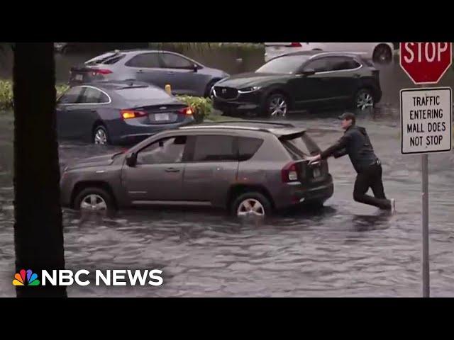 WATCH: NBC reporter pushes car out of water as severe flooding hits South Florida