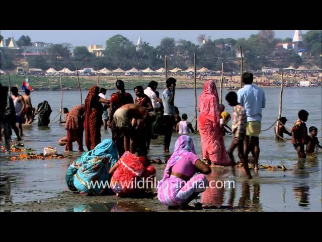 Devotees offer prayers after taking a holy bath in river Ganga