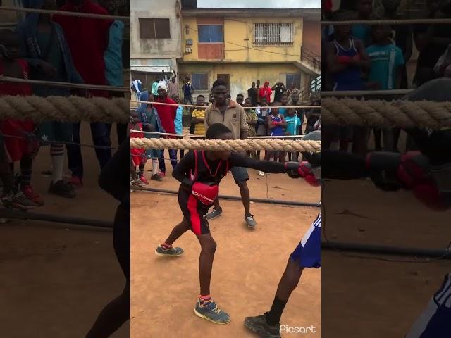 Ayomide Atanda intense sparring with a young fighter on the street of Lagos.