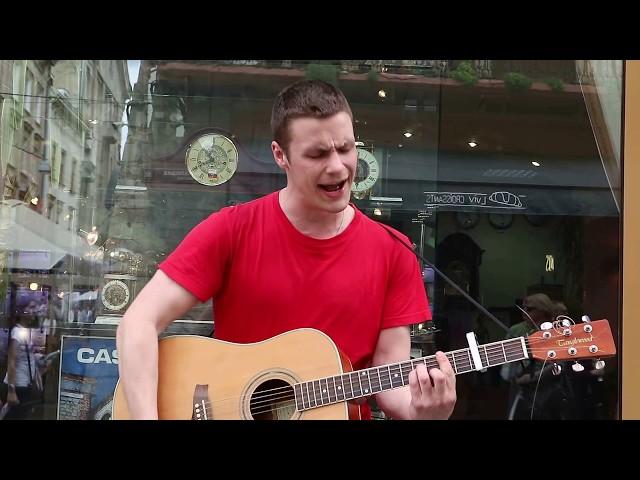 Street musician singing cover on "Queen - Bohemian Rhapsody" in Lviv