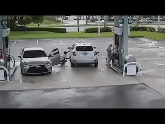 Crouching suspect steals woman's purse at gas pump
