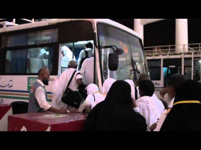 Step 14 Pilgrims entering the bus after giving the passports to the Naqaba Sayarat Official