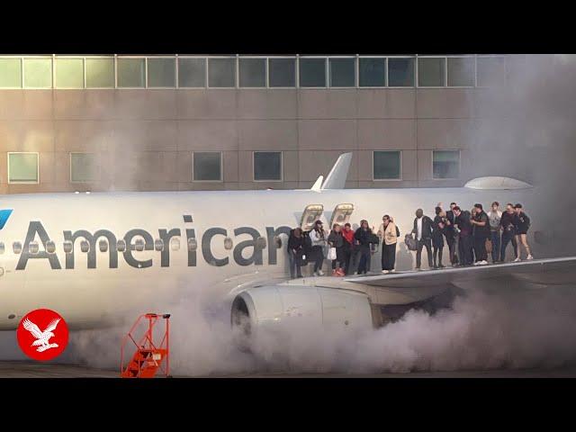 American Airlines plane bursts into flames as passengers escape on wing