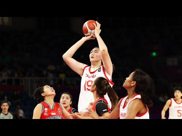 China's 7-foot-3 teen basketball star towers over her competitors in viral video