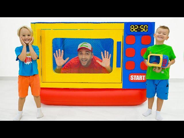 Chris and Michael pretend play with toy microwave