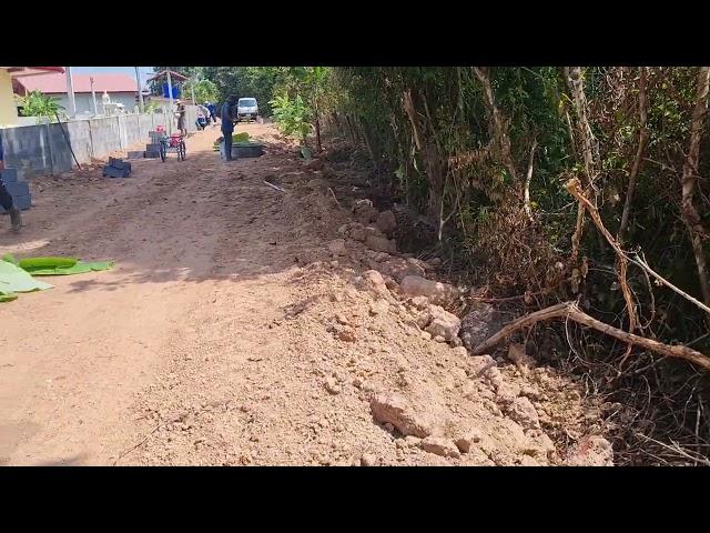 Building a farm wall in Thailand concrete blocks.