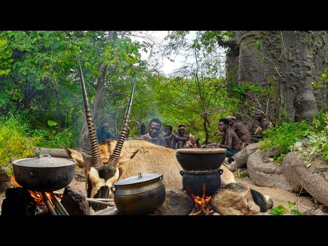 Hadza Tribe's Hunters Shelter Under Large Rock After Catching Big Animal