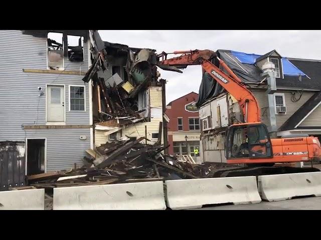 Time lapse of fire-damaged buildings getting demolished