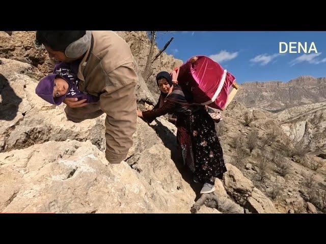 A mother with her baby in a cradle on a difficult path. Migration of nomads