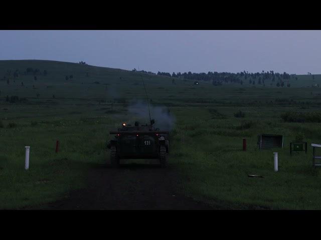 An infantry fighting vehicle (bmp-2) firing at night