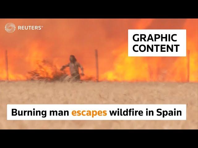 WARNING: GRAPHIC CONTENT - Burning man escapes wildfire in Spain