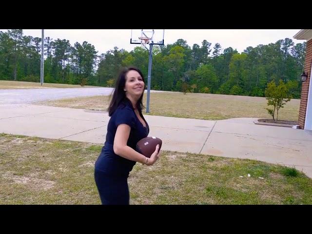 Charlotte throwing the "PassBack" football.