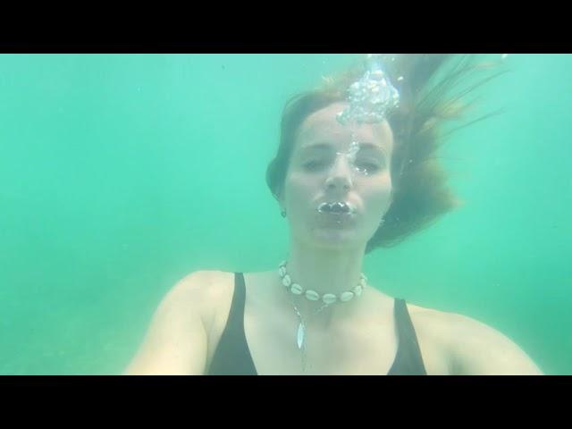 Many underwater bubbles in the sea and a lot of lying on the back