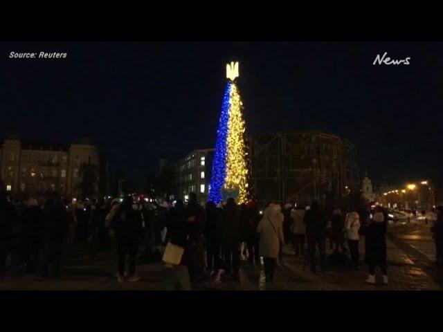 Christmas tree sparkles in dark Kyiv