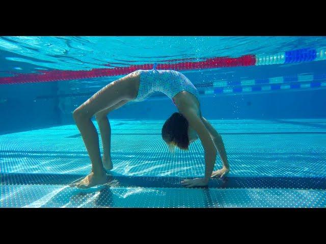 Carla underwater doing underwater gymnastics