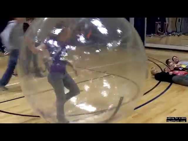 Girl in a giant Hampster ball trampling boys