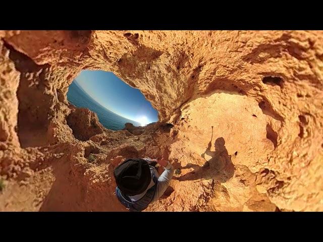 Man climbing through the rock cave, rocky coast, Algarve, Tiny planet effect, VR360, 360VR