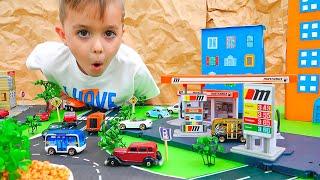 Vlad und Niki spielen mit Spielzeugautos und bauen Matchbox City