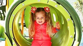 Little girl Diana have fun playing on the Outdoor playground, Kids video